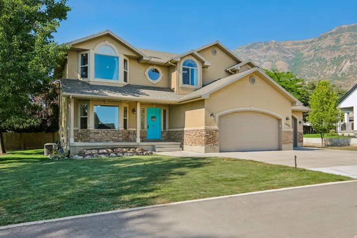 Two-story stucco residence with stone veneer accents