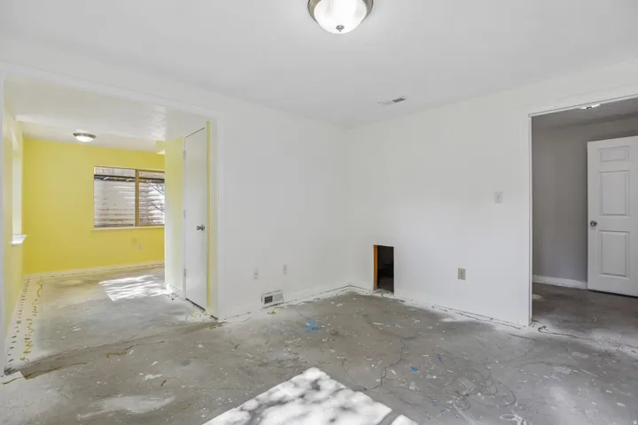 Interior space featuring white walls, concrete flooring, and a flush mount ceiling light fixture