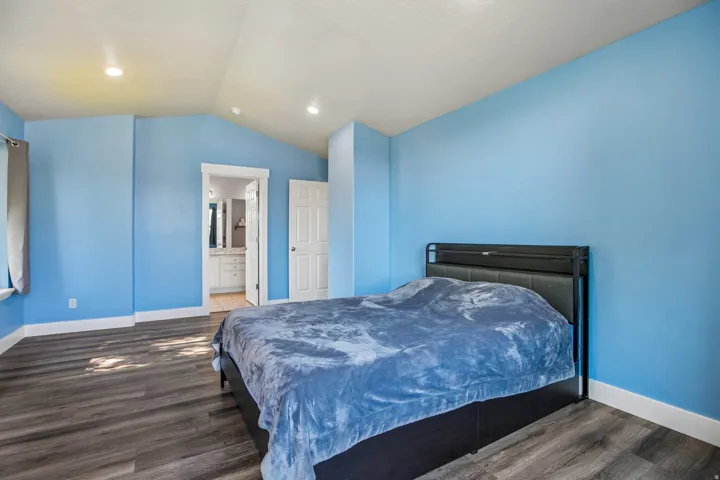Bedroom featuring vaulted ceilings and recessed lighting