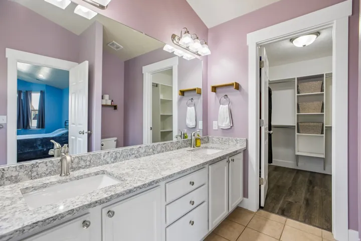 Dual vanity with integrated sinks, granite-finish countertop, and brushed nickel fixtures