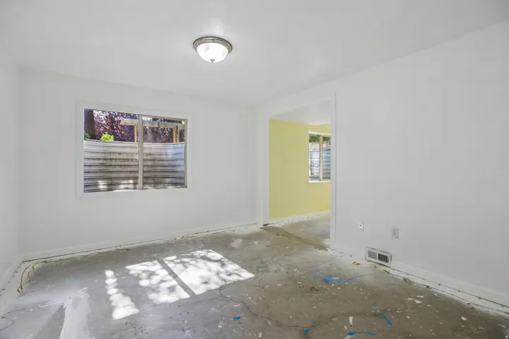Interior space featuring white walls and a white trim window