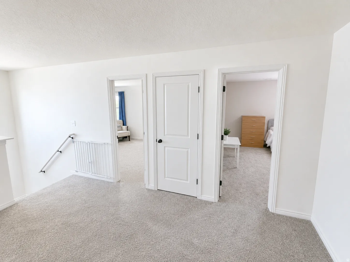 Upper-level landing featuring textured carpeting and light-toned walls