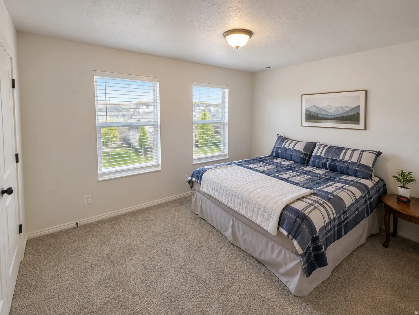Neutral-toned walls complement plush carpeting