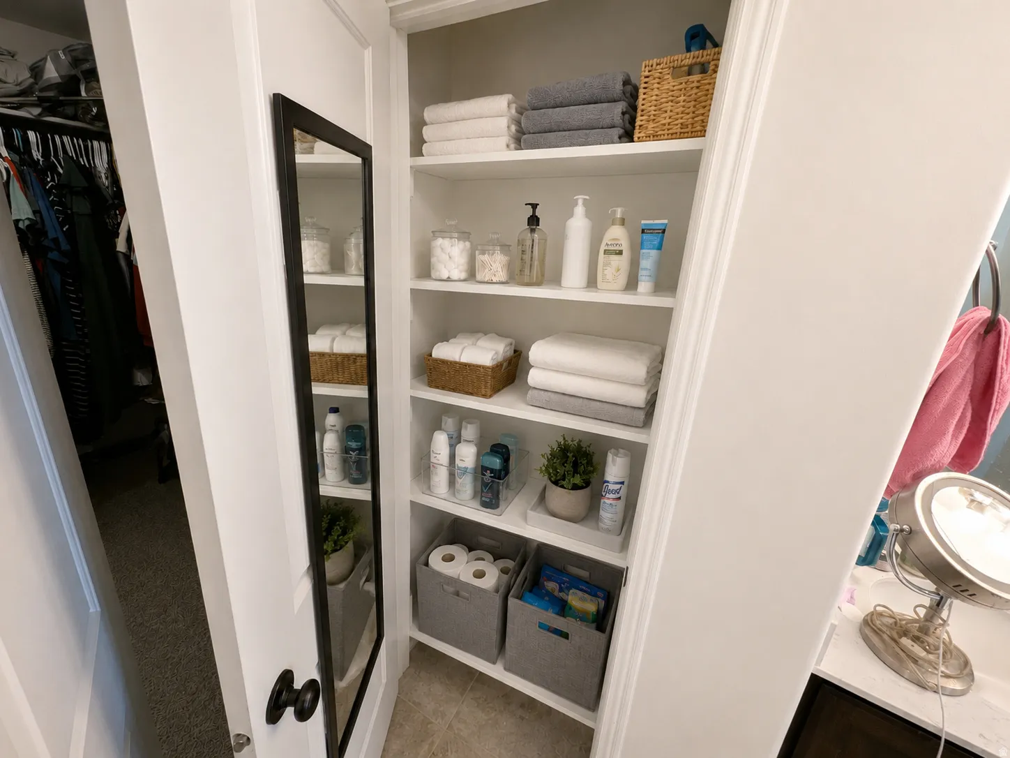 Built-in storage shelving with multiple white shelves and integrated organization