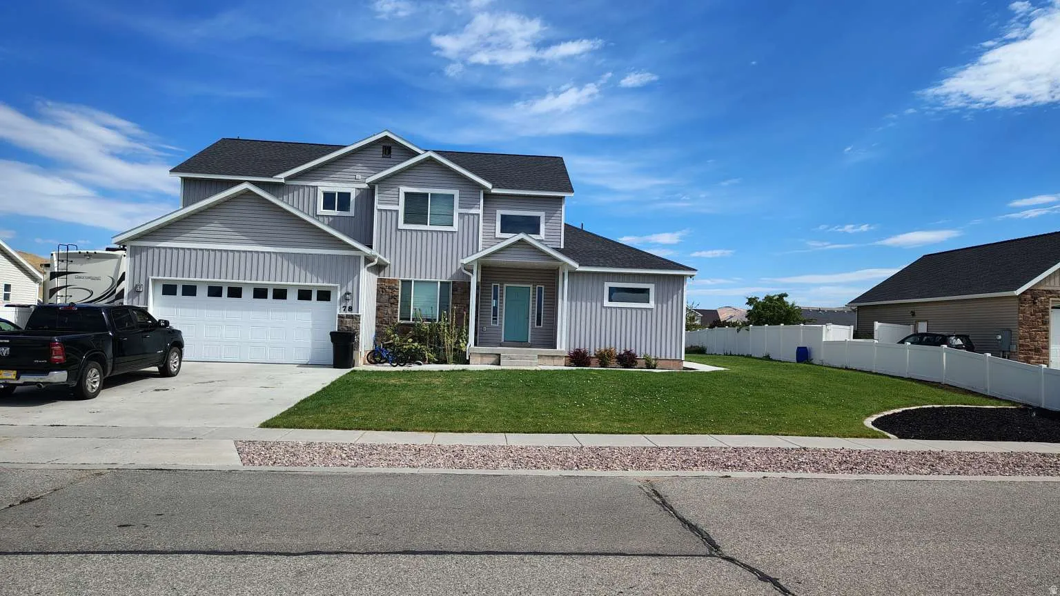Two-story residence featuring light gray siding with white trim accents