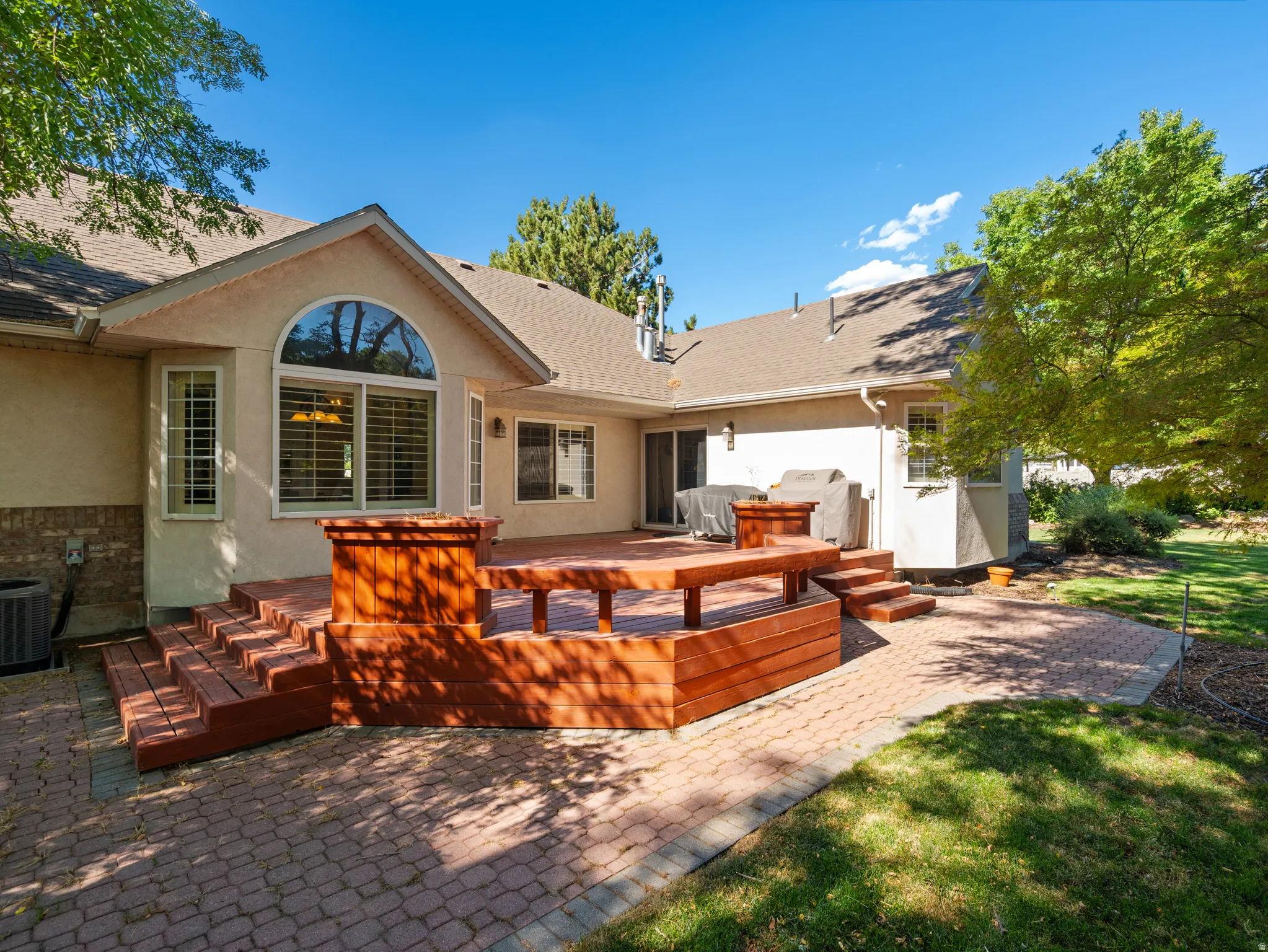 Expansive multi-level wood deck and brick paver patio