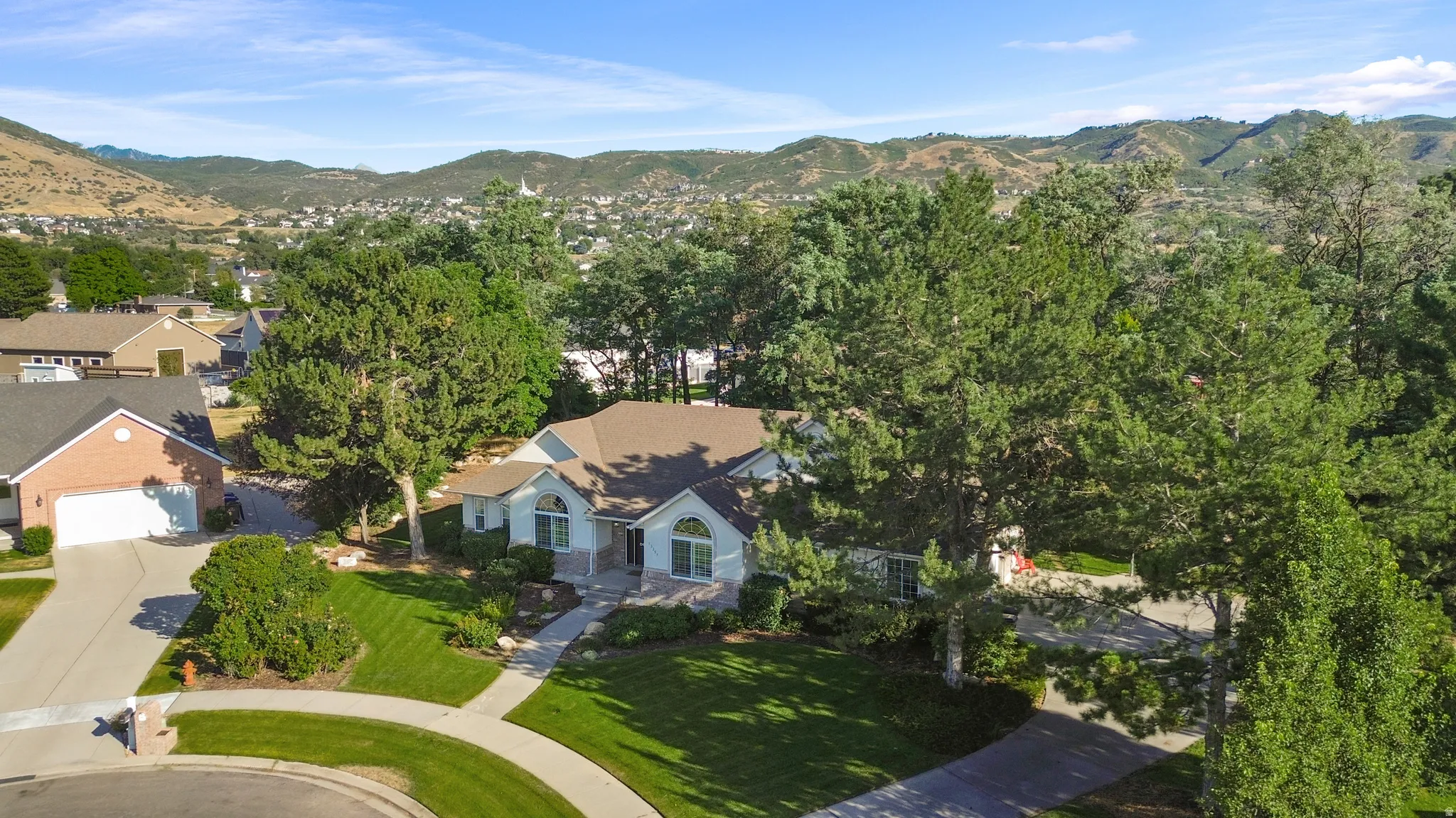 Aerial perspective showcasing the residential property set against a mountain backdrop