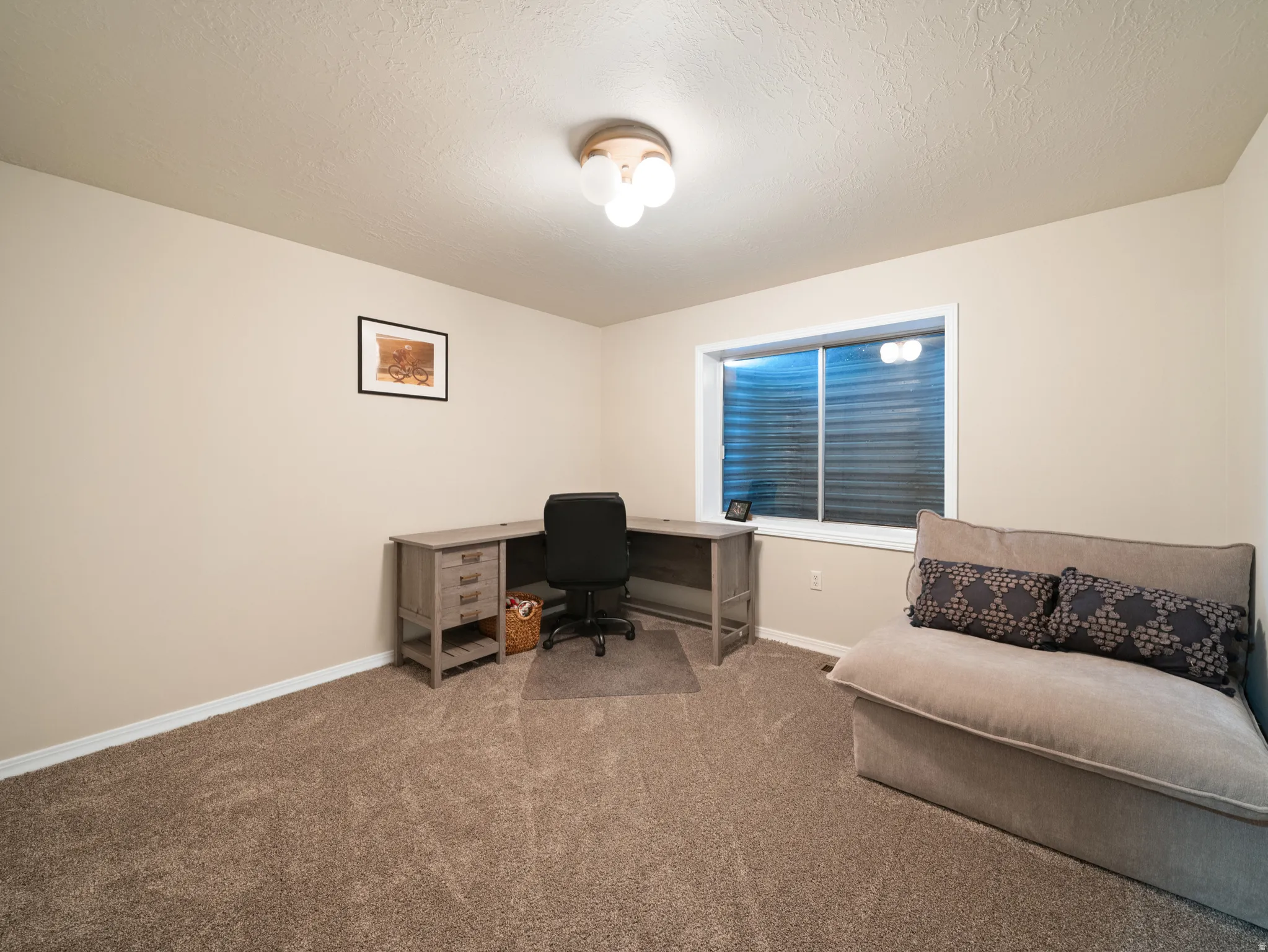 Neutral wall paint provides a versatile backdrop for this room, featuring a built-in window and overhead lighting