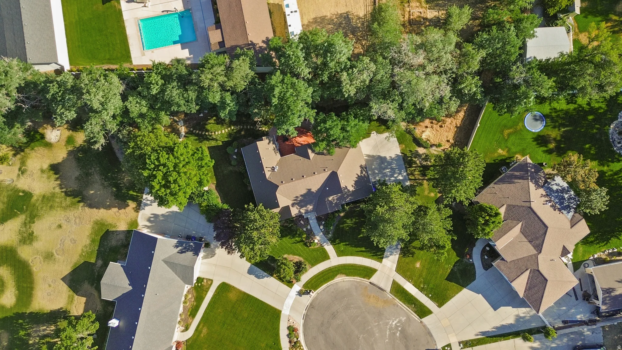 Expansive property featuring mature trees and a manicured lawn