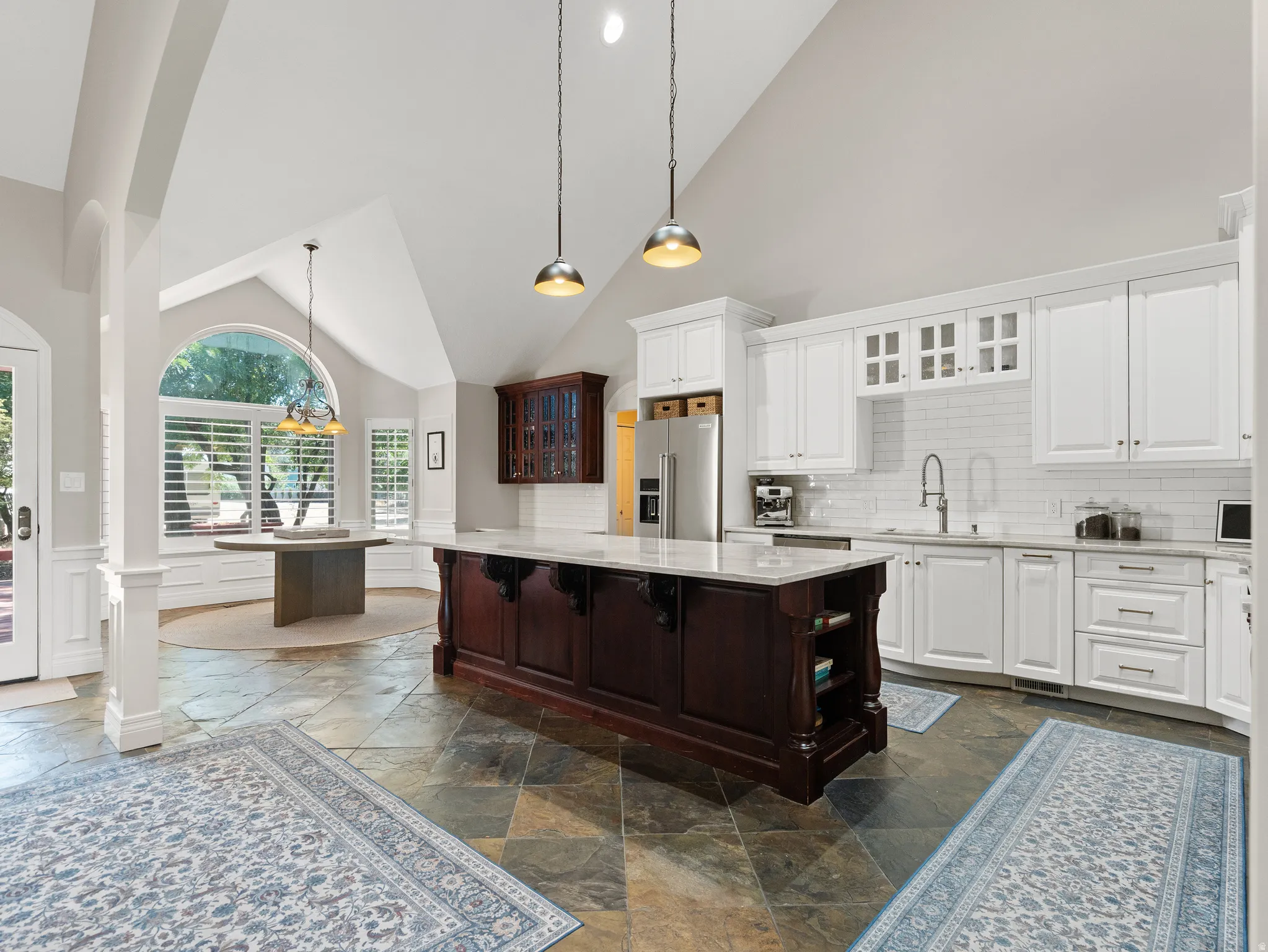 Modern kitchen featuring white cabinetry, subway tile backsplash, and stainless steel appliances