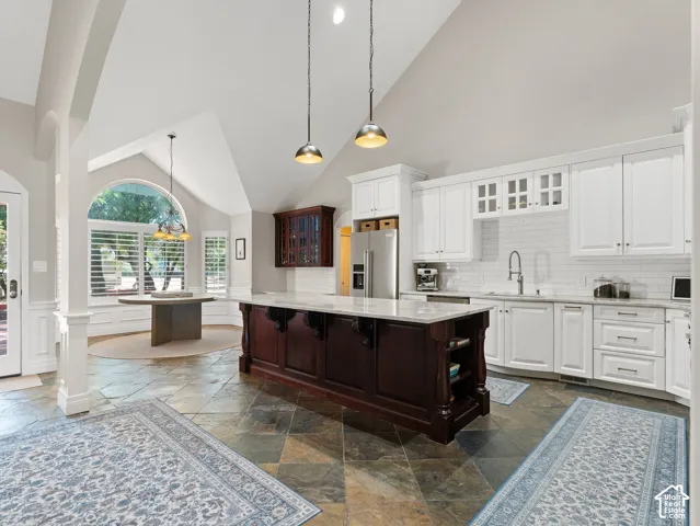 Modern kitchen featuring white cabinetry, subway tile backsplash, and stainless steel appliances