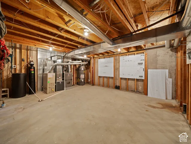 Unfinished basement featuring exposed wood joists and concrete flooring