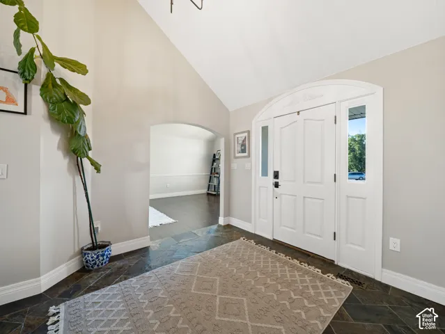 Grand entryway featuring an arched double-door system with sidelights and an upper transom window