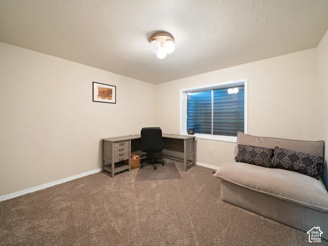 Neutral wall paint provides a versatile backdrop for this room, featuring a built-in window and overhead lighting