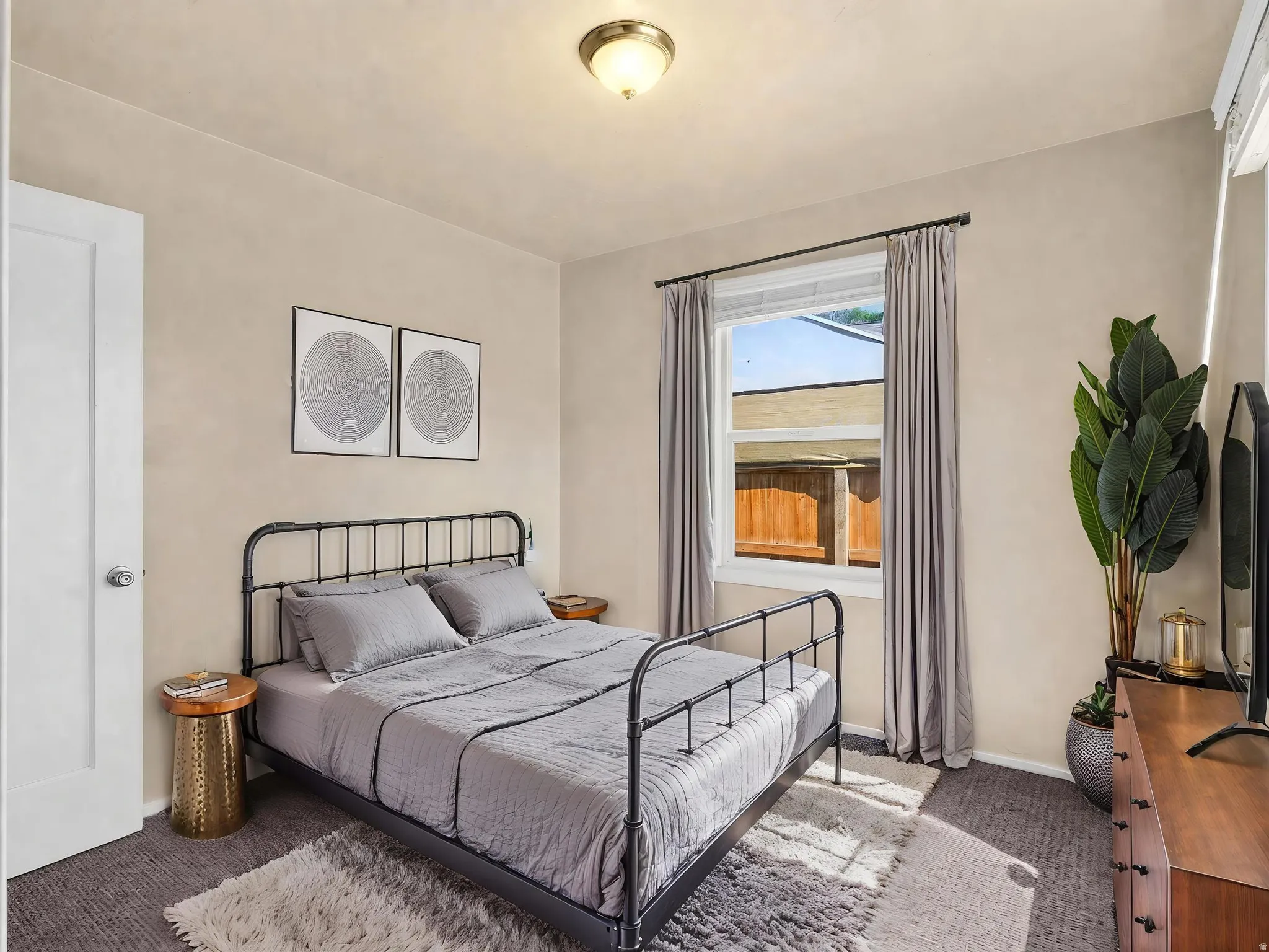 Carpeted room featuring a single window, white trim, and a flush-mount ceiling light