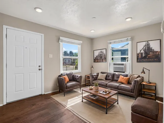 Living area featuring recessed lighting, dark wood-finish flooring, and white trim
