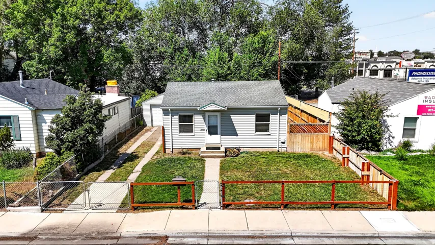 Siding exterior with a gabled roof, a front lawn, and a fenced front yard