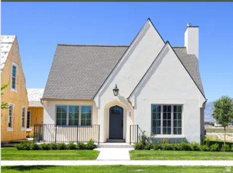 Classic white stucco exterior with a gray shingle roof
