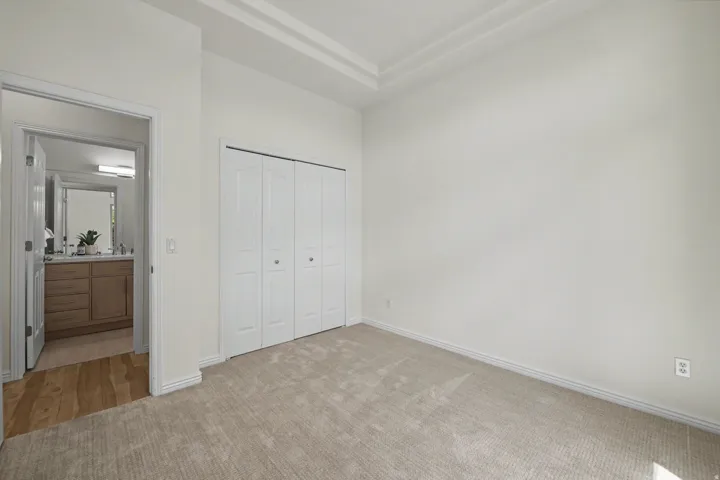 Neutral tone-on-tone carpeting with contrasting baseboards
