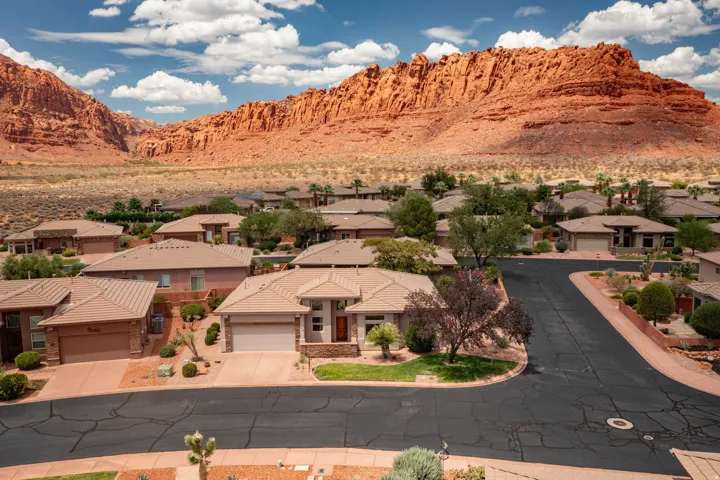 Residential area with desert landscaping set against a backdrop of red rock mountains