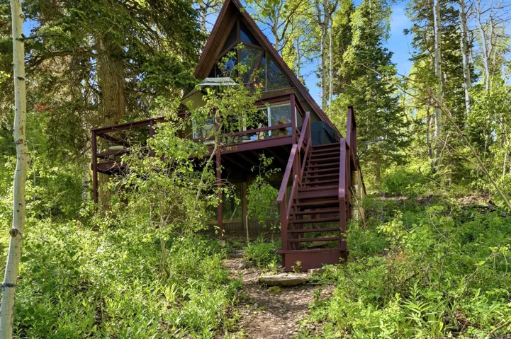 A-frame architecture with a prominent deck and exterior staircase