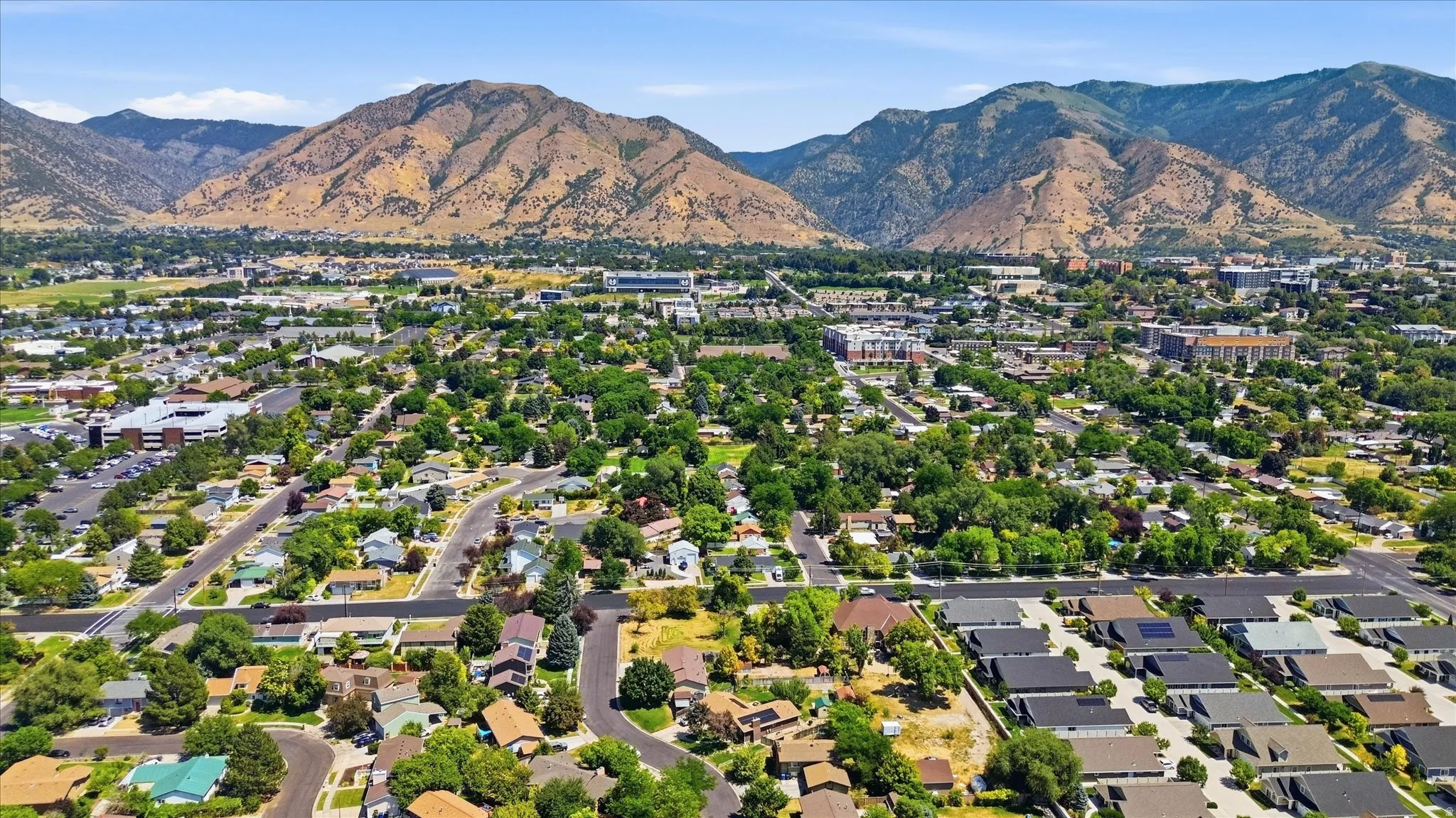 Aerial perspective showcasing a residential landscape with a prominent mountain backdrop