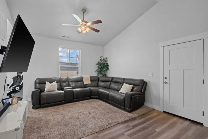 Spacious living room anchored by a charcoal sectional sofa with plush cushioning and accent pillows