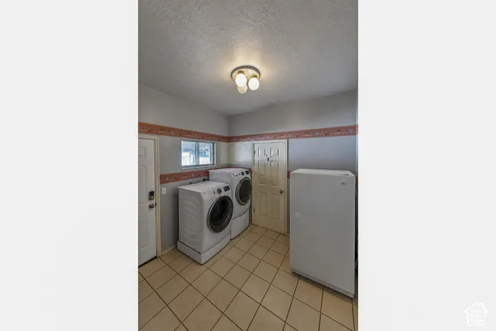 Utility space featuring tiled flooring and a flush-mount ceiling light