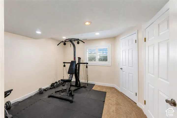 Versatile bonus room featuring recessed lighting, a window with white louvered shutters, and dual paneled doors
