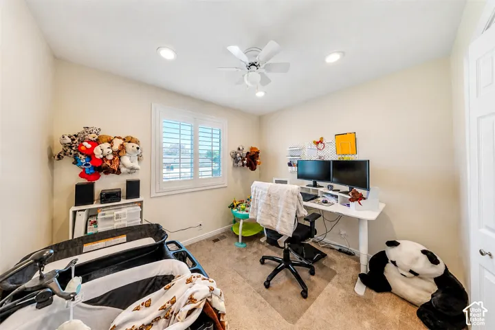 Room featuring recessed lighting, a ceiling fan, and a window with plantation shutters