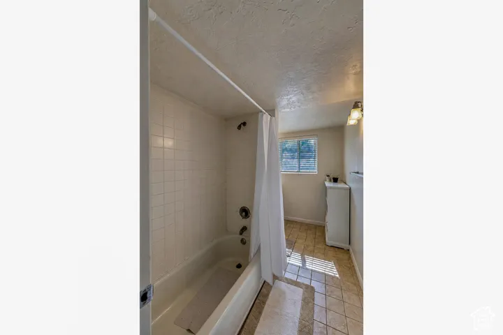 Bathroom with a built-in bathtub and tiled surround
