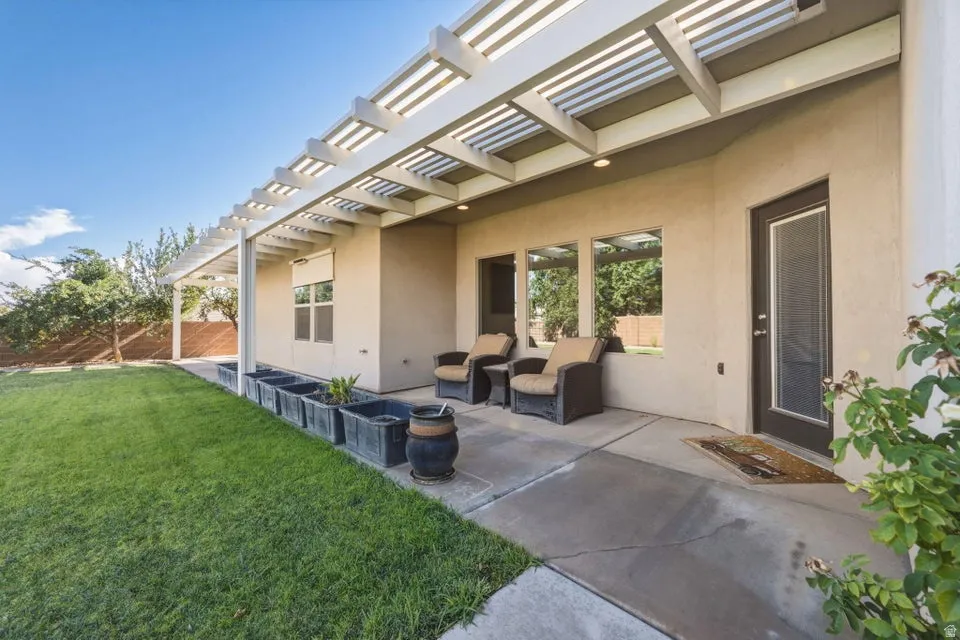 Covered patio with aluminum louvered pergola providing shade and architectural interest