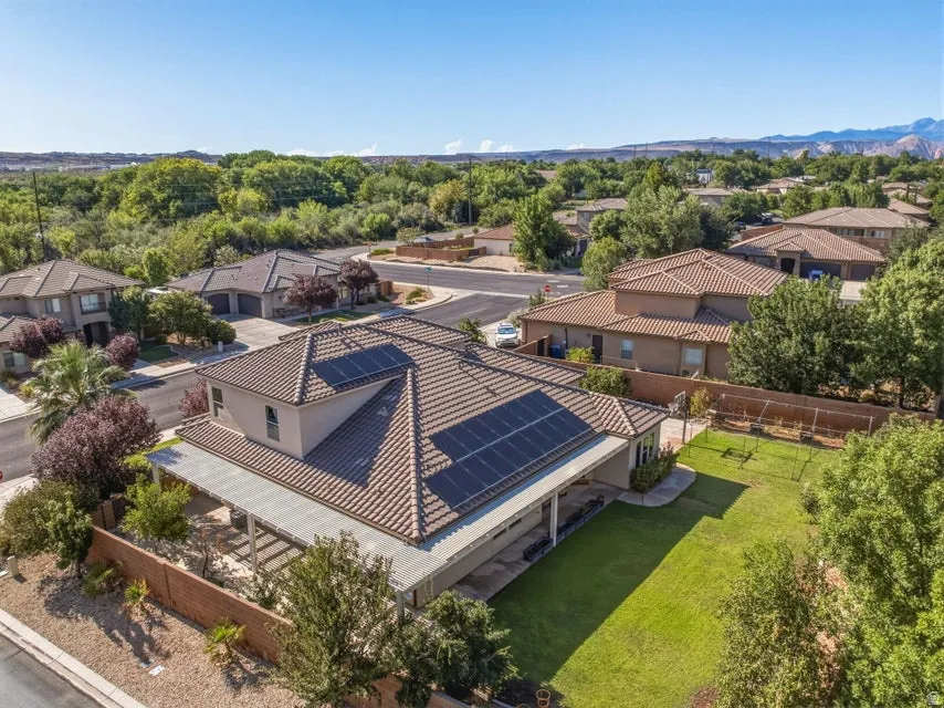 Modern residence featuring a striking tile roof and solar panel array mounted on the main structure