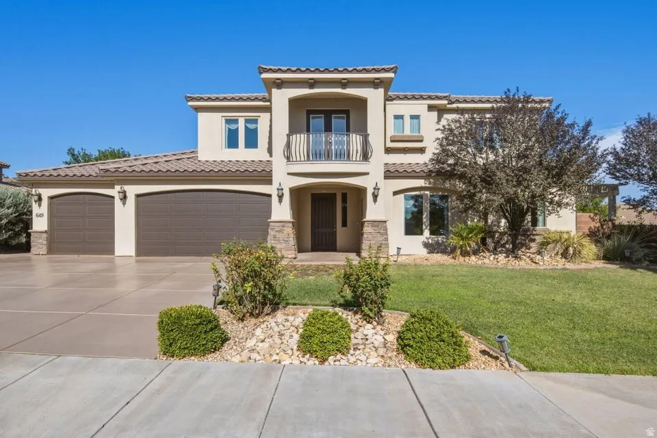 Stucco exterior with stone accents and a tile roof
