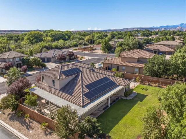 Modern residence featuring a striking tile roof and solar panel array mounted on the main structure