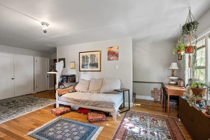 Hardwood-finish flooring throughout, complemented by white walls and trim