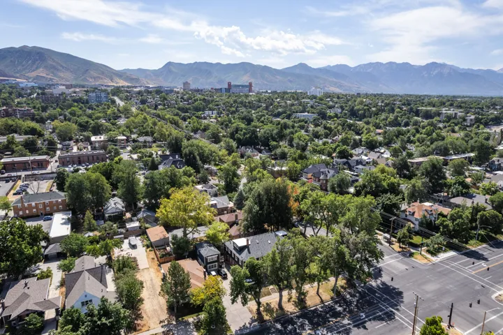Expansive neighborhood featuring mature trees, residential properties, and distant mountains