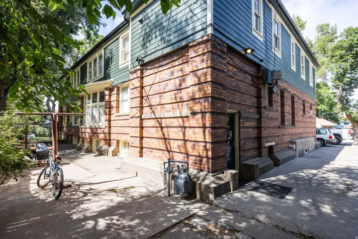 Brick and siding exterior featuring multiple windows