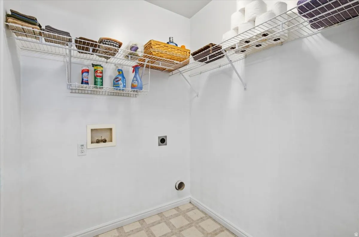 Utility closet featuring wall-mounted wire shelving with ample storage capacity, recessed lighting, and practical built-in organization