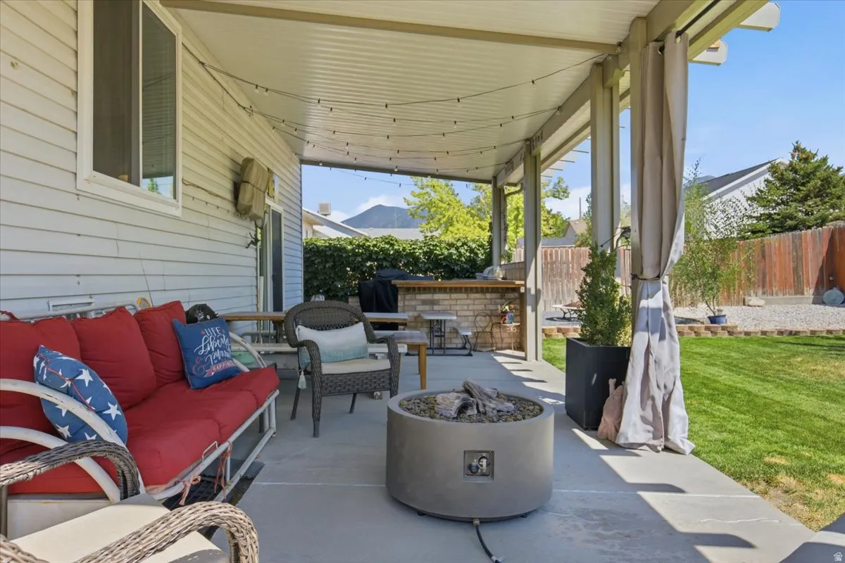 Covered patio with composite decking, integrated fire pit, and comfortable seating area