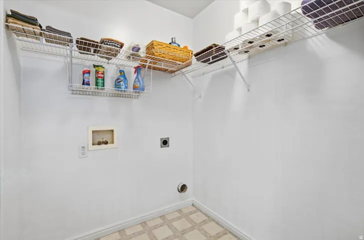 Utility closet featuring wall-mounted wire shelving with ample storage capacity, recessed lighting, and practical built-in organization