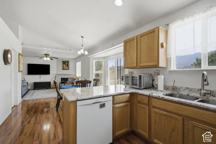Warm wood cabinetry and granite countertops define this well-appointed kitchen, appliances, and ample counter workspace