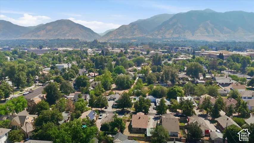 Established residential neighborhood featuring tree-lined streets, single-family homes with varied architectural styles, and mountain backdrop