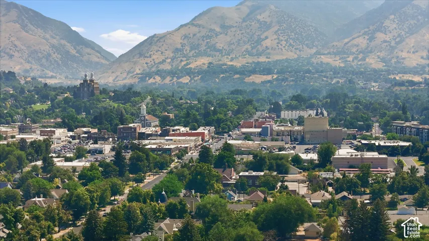 Scenic valley setting with expansive mountain backdrop and mature tree canopy