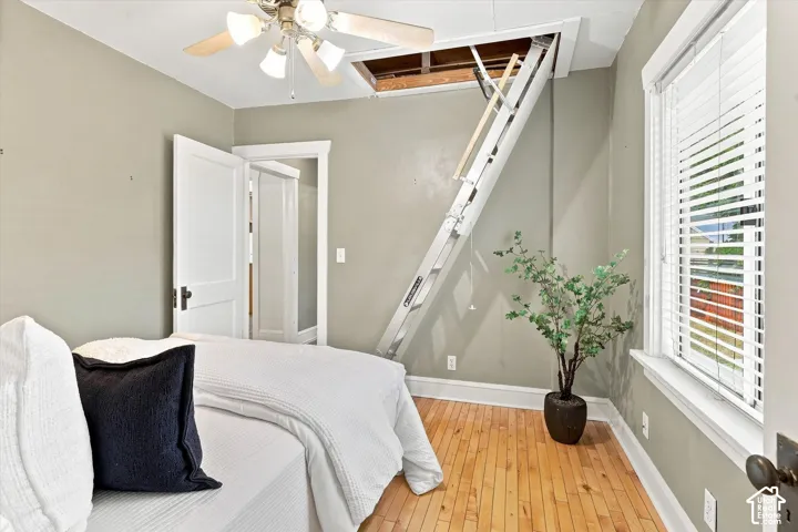 Bright bedroom with sloped ceiling and skylight flooding the space with natural light