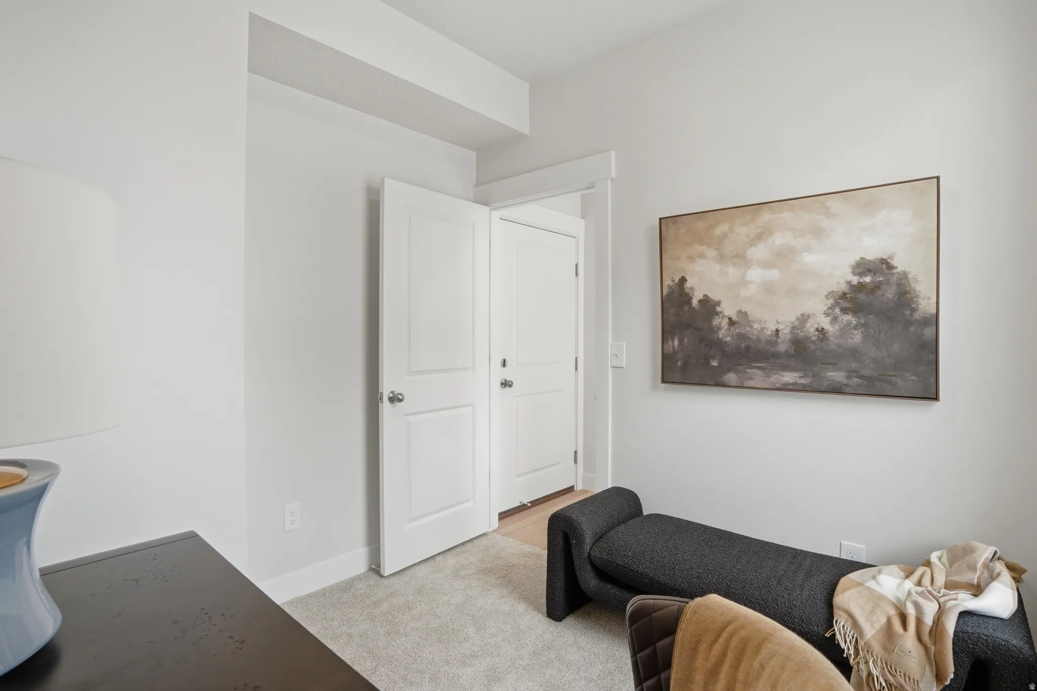 Light-colored carpeting complementing white walls and trim
