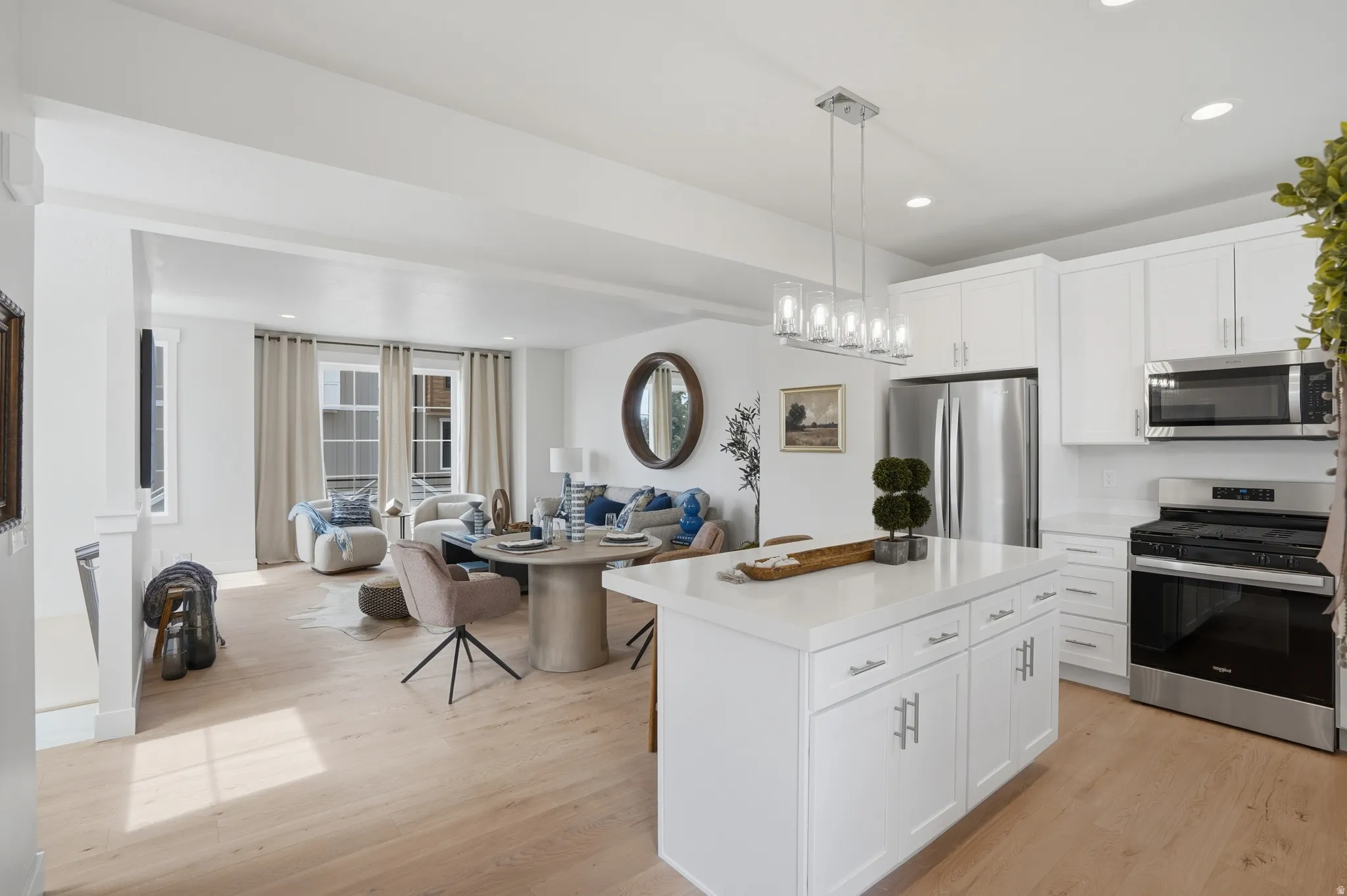 Open-concept living space featuring light wood-finish flooring throughout