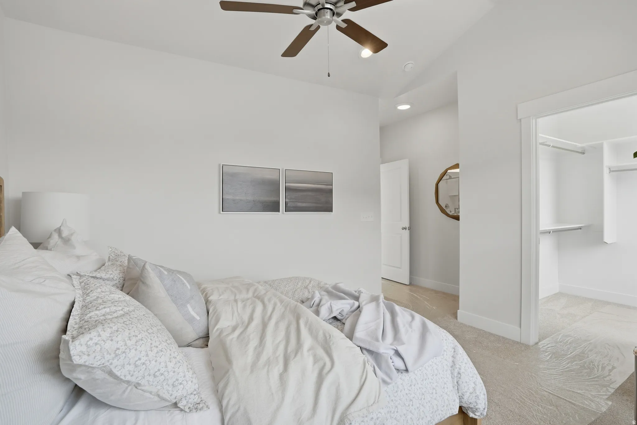 Carpeted room featuring a ceiling fan with integrated lighting, recessed lighting, and a built-in closet with shelving
