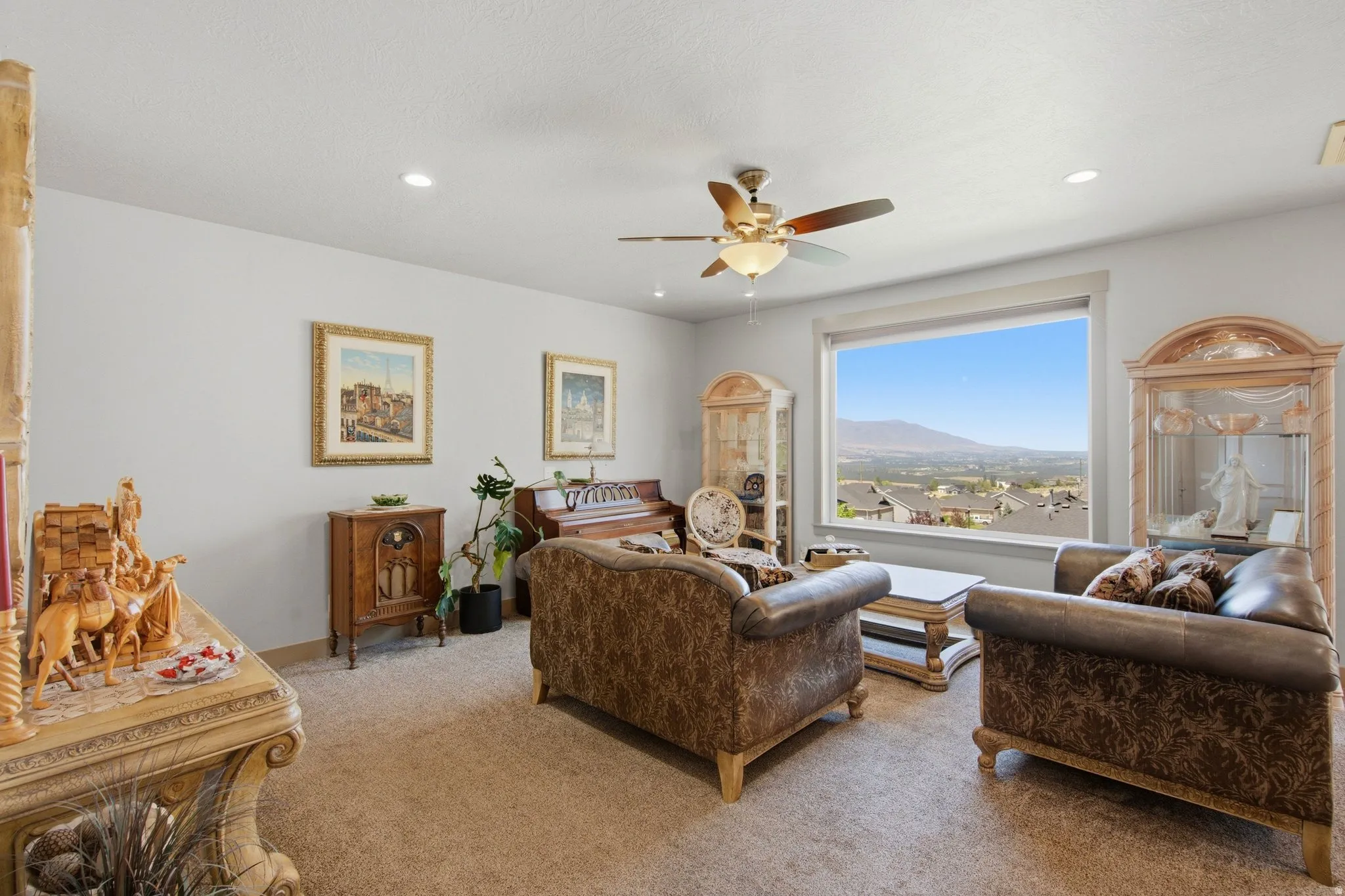 Large window framing distant mountains and community structures