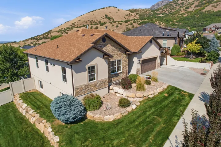 Siding exterior with stone accents and a two-car attached garage